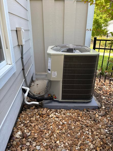 Outdoor condenser unit installed on a rock pad