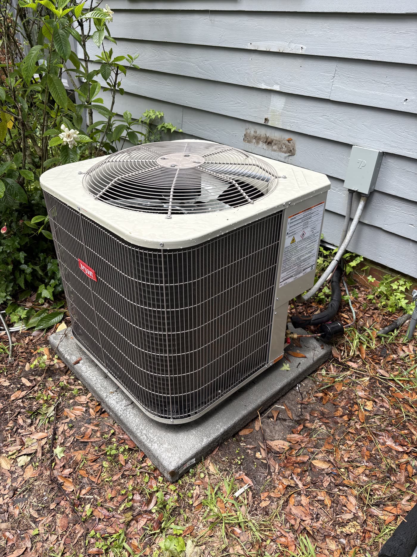 Bryant outdoor condenser unit installed on a concrete pad